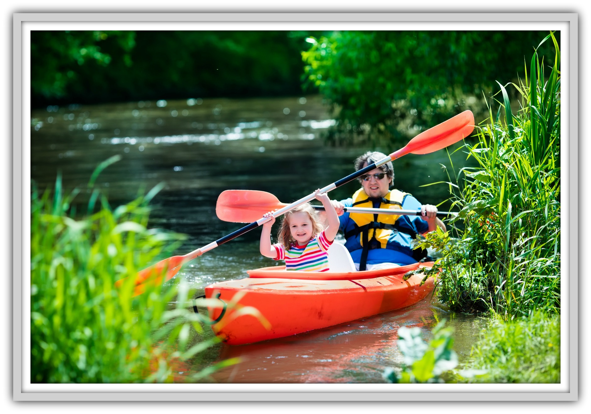 Family on kayaks and canoe tour. Father and child paddling in kayak in a river on a sunny day. Children in summer sport camp. Active preschooler kayaking in a lake. Water fun during school vacation.